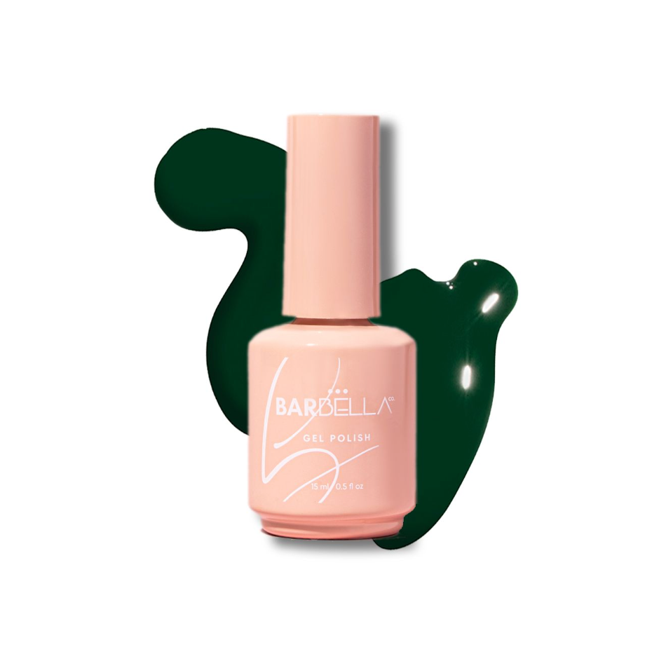 Peach BarBella Co. polish bottle on a swatch of deep forest green polish.