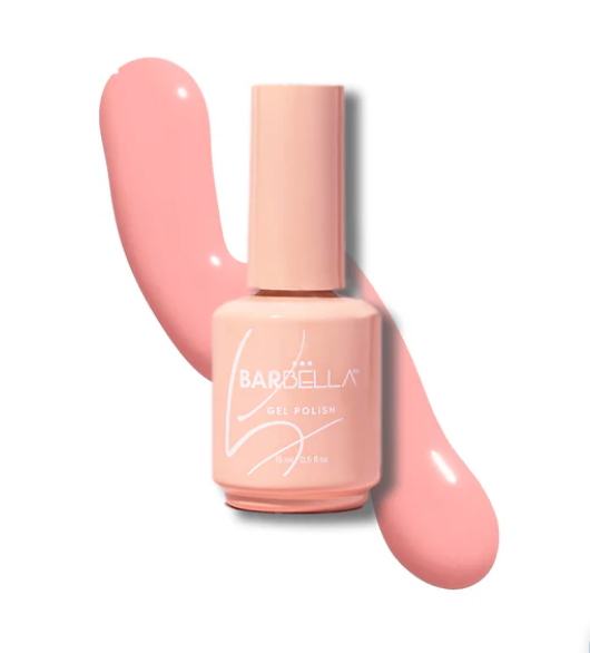 Peach BarBella Co. gel polish bottle on a swatch of soft pastel pink polish, the ballet core nail color.